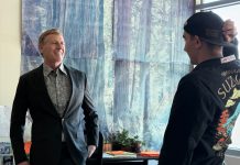 educator named grand marshal of parade speaks with student