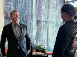 educator named grand marshal of parade speaks with student