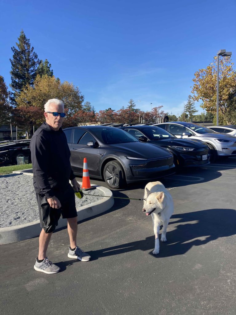 man and dog at the car event