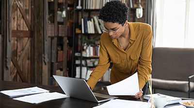 Businesswoman uploading legal advertisement with her laptop computer.