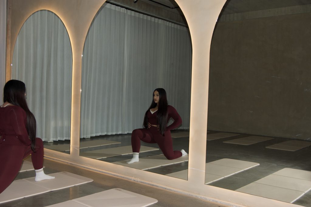 pilates business owner stretching