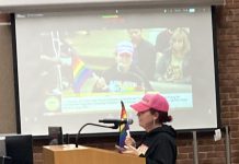 Amid strident disagreement, Los Gatos votes to move forward with Pride Flag plan woman with rainbow flag during public comment in Los Gatos
