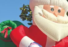 Winter here is wonderful, with the tree lighting, a parade and trolley rides two kids on a float with an inflatable Santa behind them