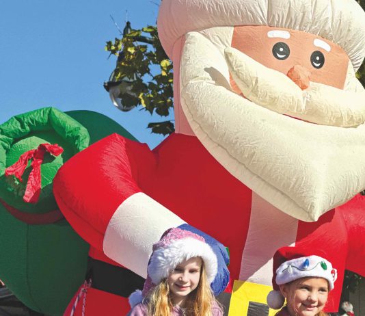 Winter here is wonderful, with the tree lighting, a parade and trolley rides two kids on a float with an inflatable Santa behind them