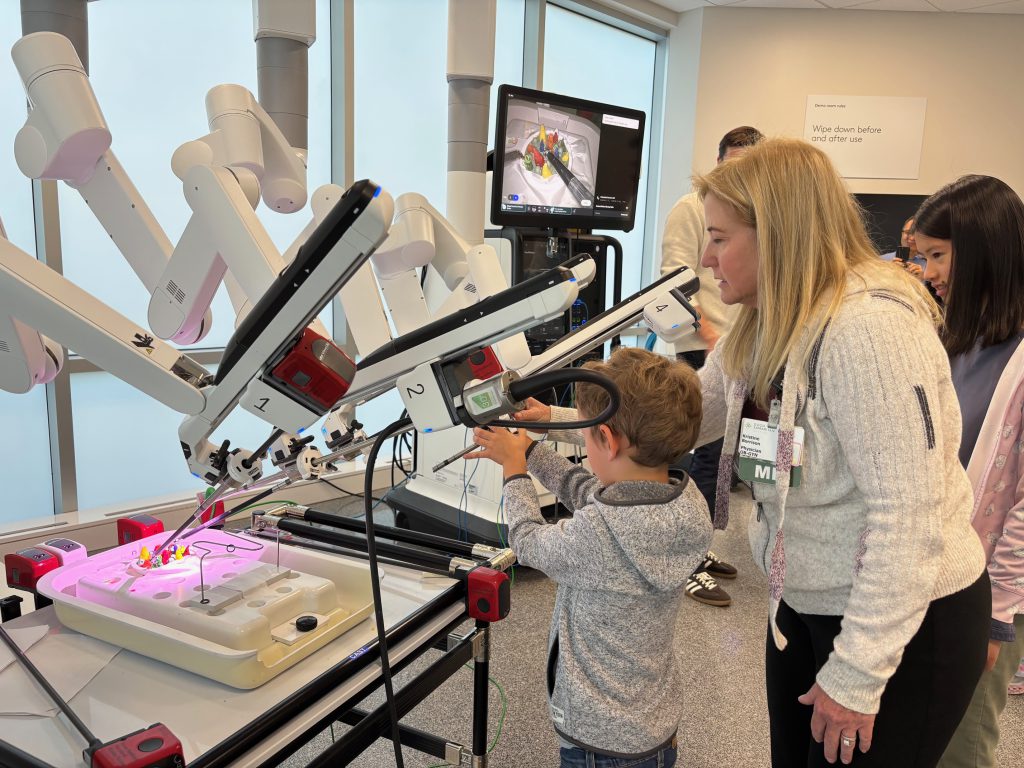 child plays with a surgery robot