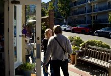 Purple Onion owner holds the door for a customer