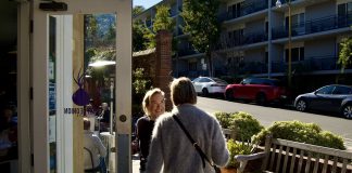 Purple Onion owner holds the door for a customer