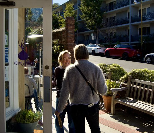 Purple Onion owner holds the door for a customer