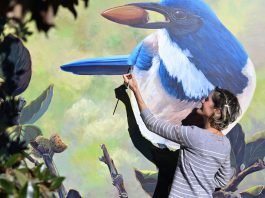 Morgan Bricca with bird mural at Whole Foods