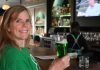 woman drinking green beer