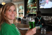 woman drinking green beer