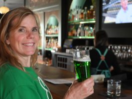 woman drinking green beer