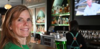 woman drinking green beer