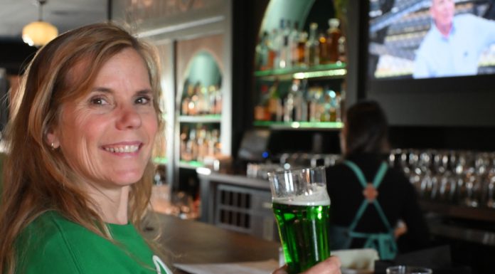 woman drinking green beer