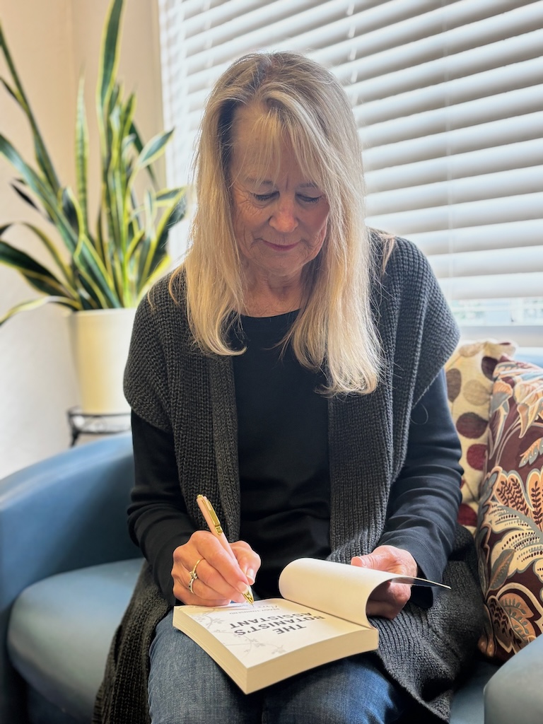 Peggy Townsend signs a copy of The Botanist’s Assistant