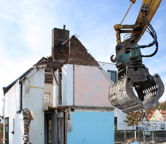 housing being torn apart by a machine