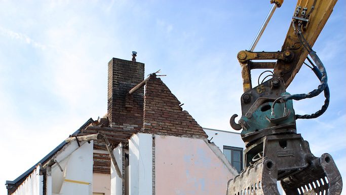 housing being torn apart by a machine