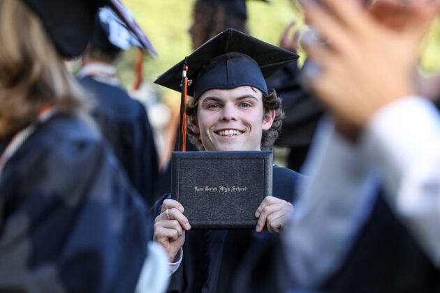 showing his diploma