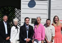 group shot by the plaque