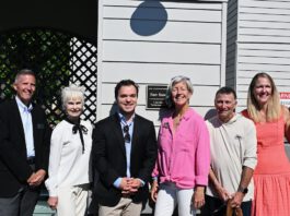 group shot by the plaque