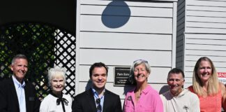 group shot by the plaque