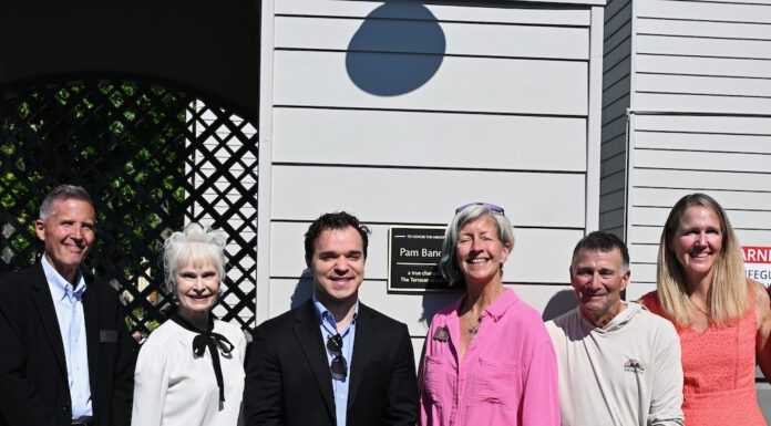 group shot by the plaque