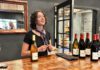 woman behind the counter with wine