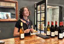 woman behind the counter with wine