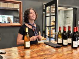 woman behind the counter with wine