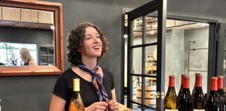 woman behind the counter with wine