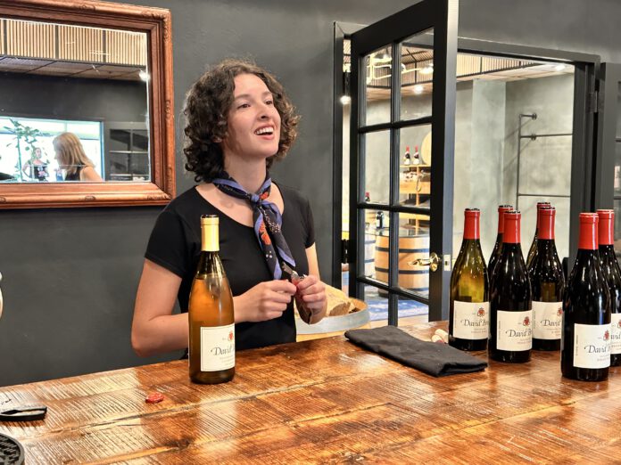 woman behind the counter with wine