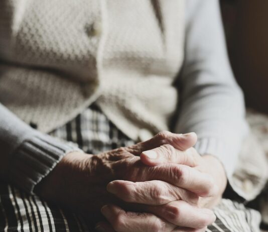 senior clasped hands