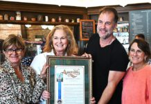 Gail Pellerin hands cafe an award