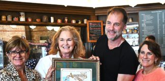 Gail Pellerin hands cafe an award