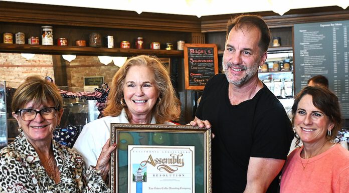 Gail Pellerin hands cafe an award