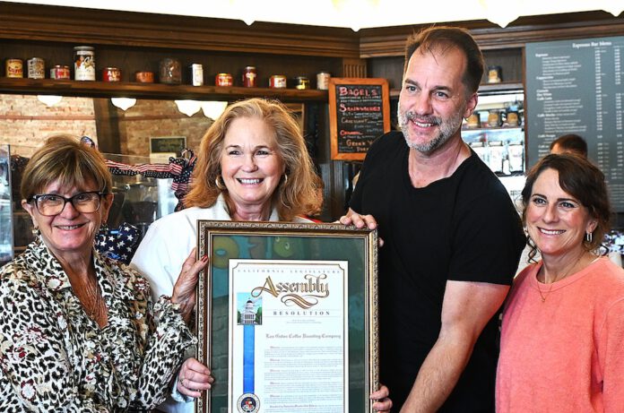 Gail Pellerin hands cafe an award