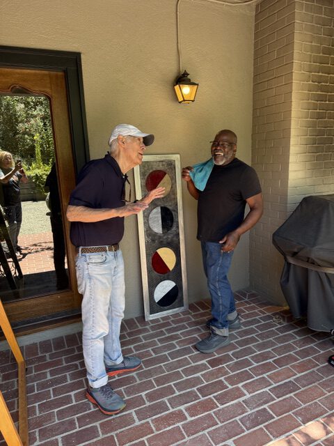 Lon Allan instructs on installing art
