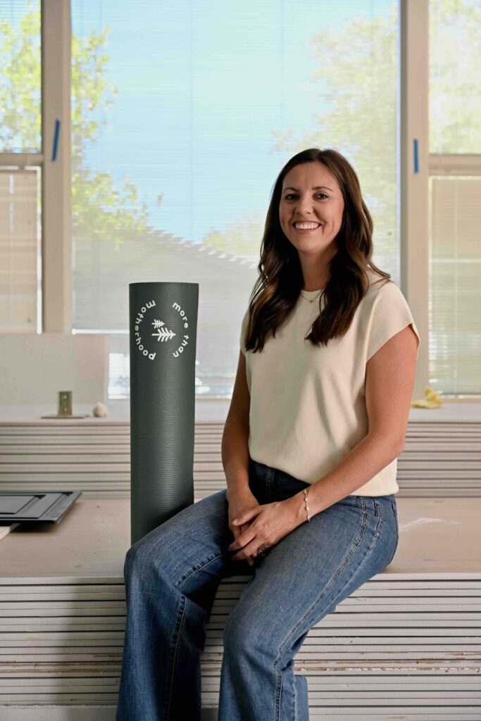 Mancini, seated by yoga mat