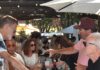 Wineries aim to overcome sales slump, Canadian cold shoulder with new approach to funding marketing pouring wine on the patio under the redwoods