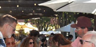 pouring wine on the patio under the redwoods