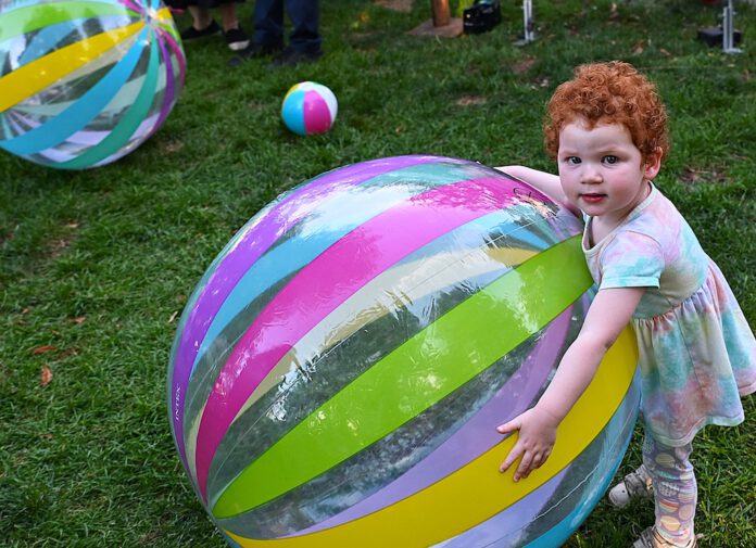 Elena Wingo big beach ball and child
