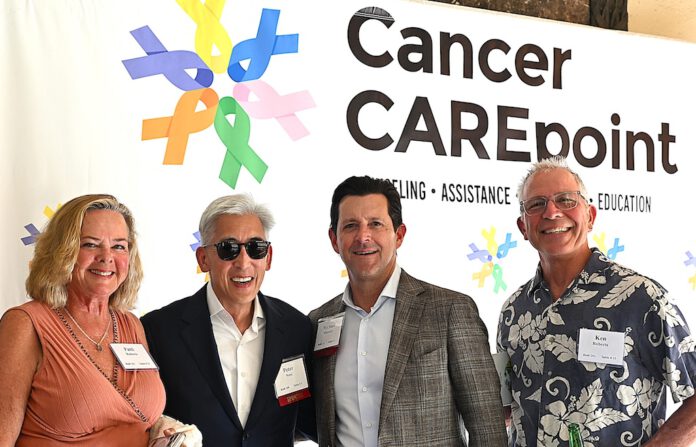 Group Shot - Patti Roberts, Peter Nose, Michael Mulcahy and Ken Roberts in front of the Cancer CAREpoint banner