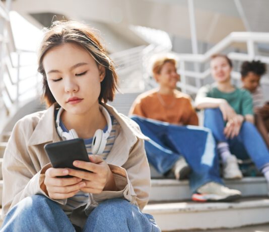 A student’s perspective on the youth mental health crisis Asian student looking somewhat despondent