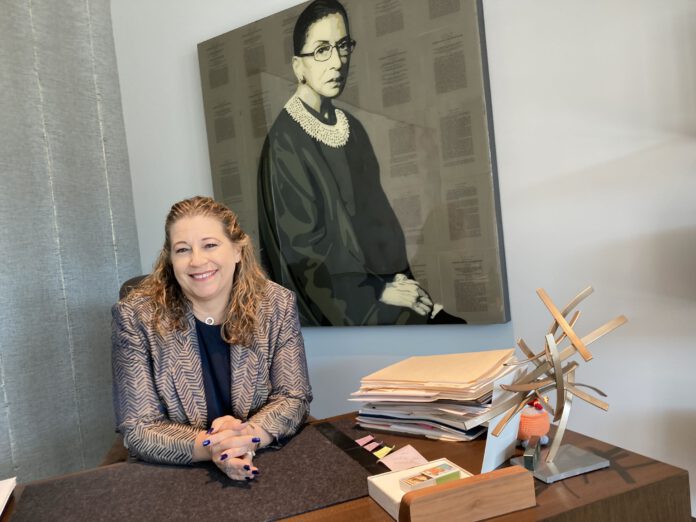 Shannon Hunt-Scott in front of Bader Ginsburg painting