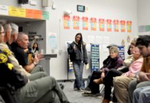 Santa Cruz County sheriff holds mountain meeting about potential release of ‘sexually violent predator’ Michael Cheek to Los Gatos neighborhood undersheriff addresses the crowd while seated. crowd looks distraught.