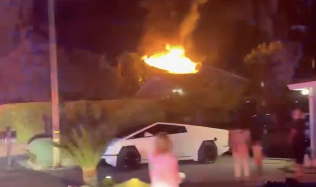 fire in the background as neighbors watch