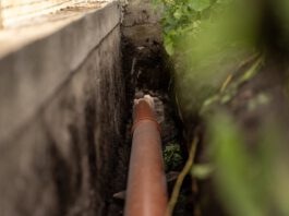 The sewage system you own but have never seen ORANGE PLASTIC This sewage pipe was laid inside a deep narrow trench along a concrete foundation wall. (Shutterstock)